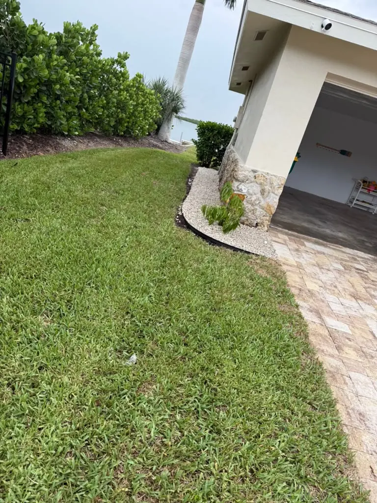 Green lawn beside a paver driveway