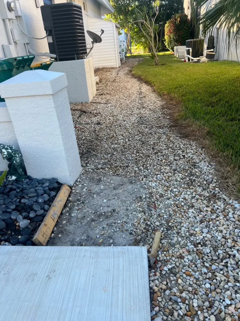River rock landscape bed along a side yard