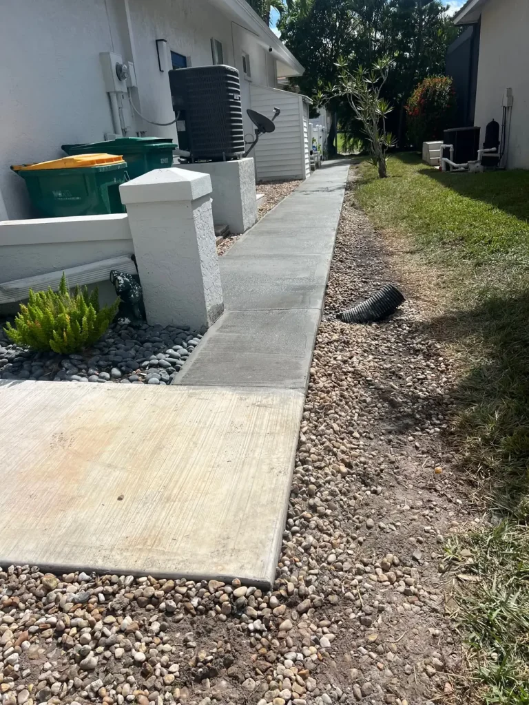 Side yard walkway with rock landscape bed